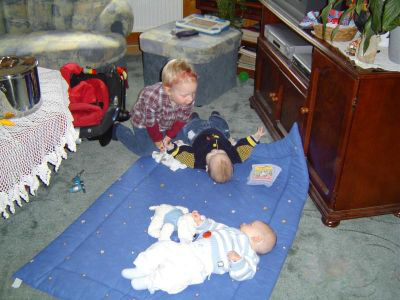 Ein Kind kuckt auf zwei Babys